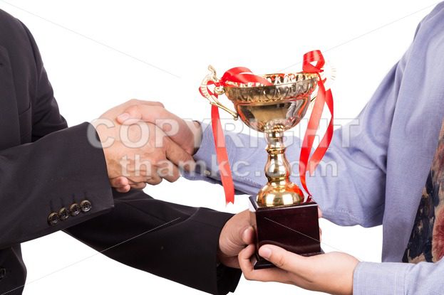 Asian business man shake hand and receive golden trophy - ThamKC Royalty-Free Photos