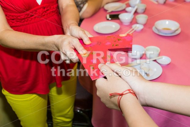 Chinese person giving red packet with Good Luck Chinese word - ThamKC Royalty-Free Photos