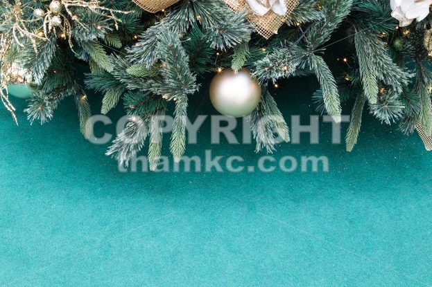 Closeup of Christmas tree with ornaments and green background - ThamKC Royalty-Free Photos