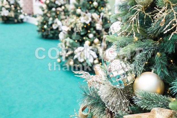 Closeup of Christmas tree with ornaments and green background - ThamKC Royalty-Free Photos