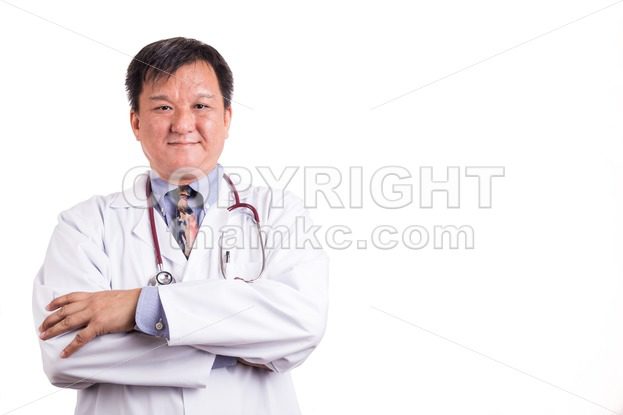 Confident matured Asian doctor with folded arms - ThamKC Royalty-Free Photos