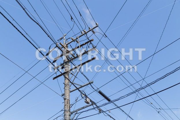 Electricity pole with wires grid with blue sky - ThamKC Royalty-Free Photos