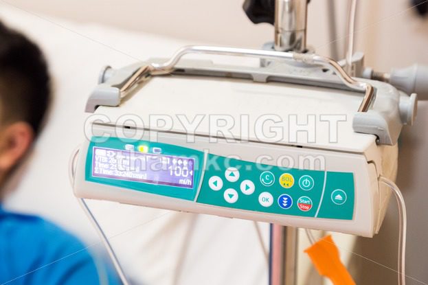 IV infusion pump regulator with patient at background - ThamKC Royalty-Free Photos