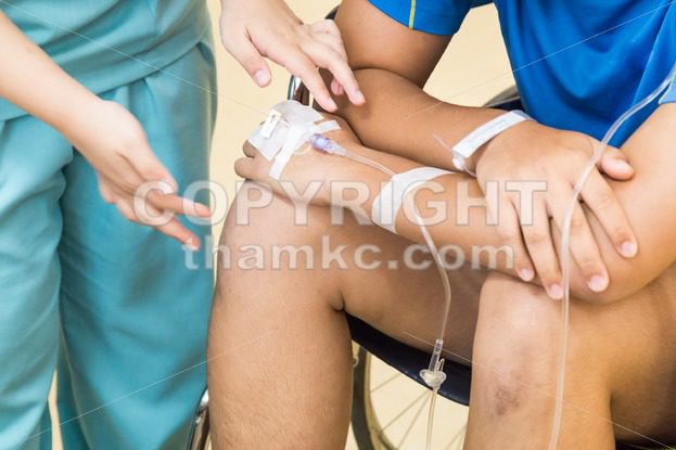 Nurse attending patient  with intravenous iv - ThamKC Royalty-Free Photos