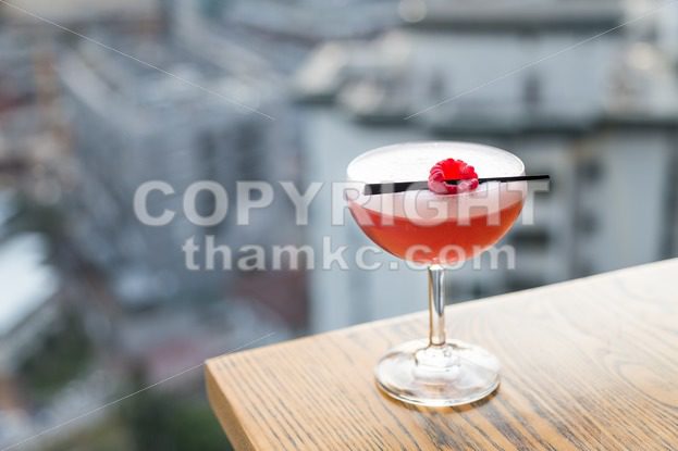 Red cocktail with cherry on table top - ThamKC Royalty-Free Photos