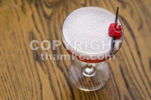 Red cocktail with cherry on table top - ThamKC Royalty-Free Photos
