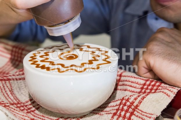 Series of person decorating coffee with art - ThamKC Royalty-Free Photos