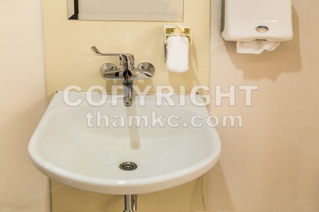 Washbasin with soap hand sanitizer and tissue paper - ThamKC Royalty-Free Photos