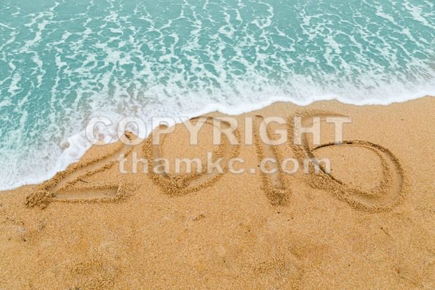 2016 inscription on sandy beach washed off with approaching wave - ThamKC Royalty-Free Photos