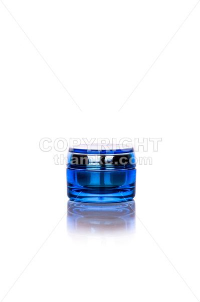 Blue skincare cosmetic jar on vertical background - ThamKC Royalty-Free Photos