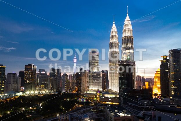 KUALA LUMPUR, MALAYSIA – JULY 23, 2016: View of the Petronas Twin Towers and KL Tower at KLCC City Center during dusk hour.  The most popular tourist destination in Malaysian capital - ThamKC Royalty-Free Photos
