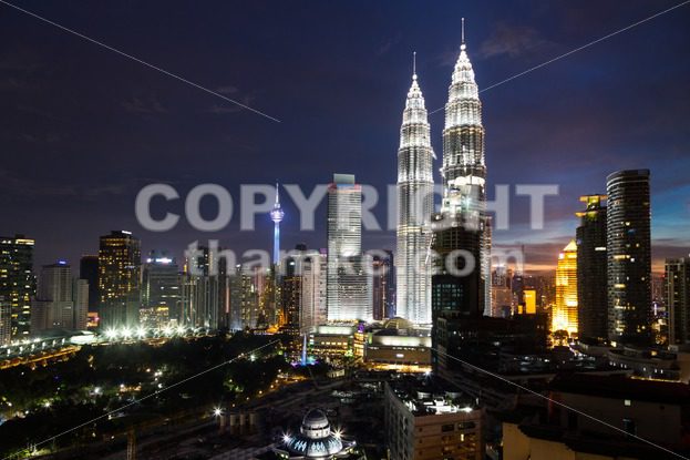 KUALA LUMPUR, MALAYSIA – JULY 23, 2016: View of the Petronas Twin Towers and KL Tower at KLCC City Center during dusk hour.  The most popular tourist destination in Malaysian capital - ThamKC Royalty-Free Photos