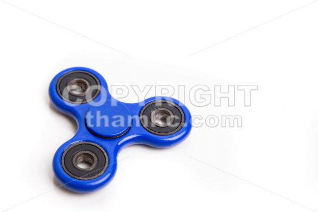 Blue fidget spinner in white background - ThamKC Royalty-Free Photos
