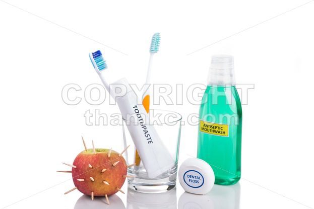 Conceptual of model mouth bite  apple with thorns, toothbrush, toothpaste, - ThamKC Royalty-Free Photos