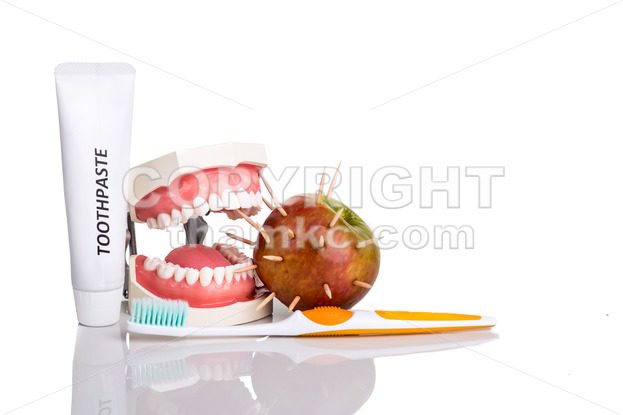 Conceptual of model mouth bite  apple with thorns, toothbrush, toothpaste, - ThamKC Royalty-Free Photos