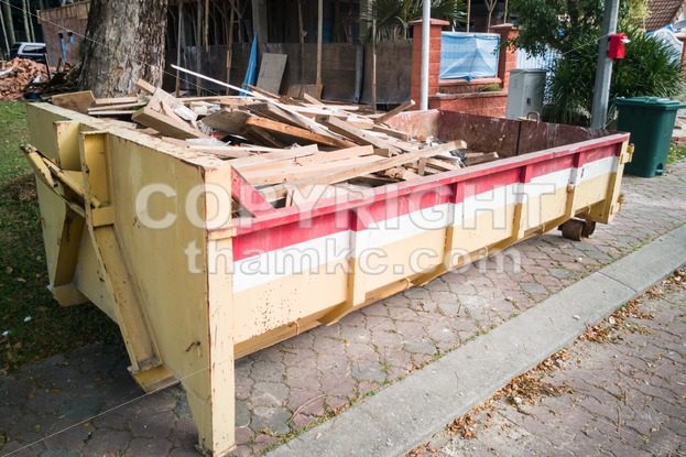 Construction rubbish dumpster with waste at construction site - ThamKC Royalty-Free Photos