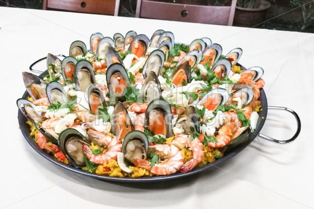 Delicious spanish paella rice with prawn, mussels, squids in pan - ThamKC Royalty-Free Photos