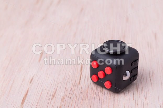 Fidget cube, the stress relieving cube on table top - ThamKC Royalty-Free Photos