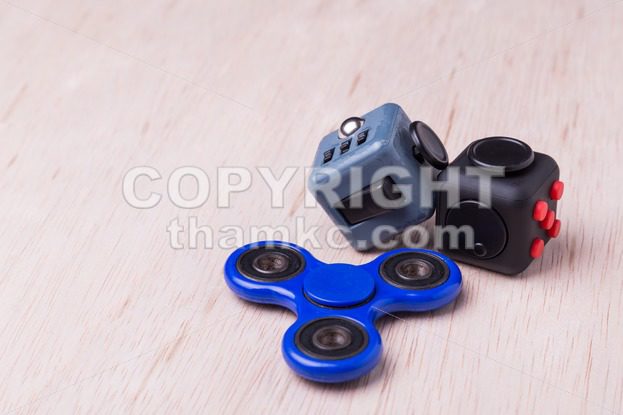 Fidget spinner and fidget cube, the latest stress relieving craze - ThamKC Royalty-Free Photos