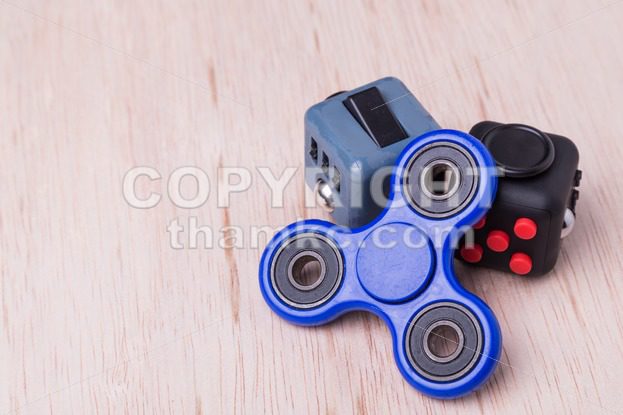 Fidget spinner and fidget cube, the latest stress relieving craze - ThamKC Royalty-Free Photos