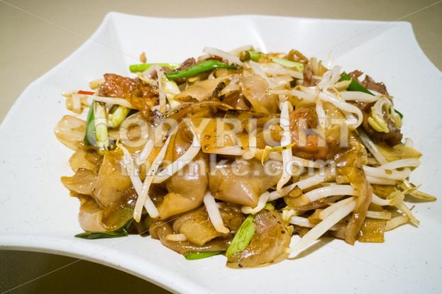 Fried Kuey Teow with beef, popular in Malaysia - ThamKC Royalty-Free Photos