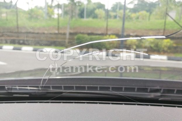 Perspective view of cracked car windscreen or windshield - ThamKC Royalty-Free Photos