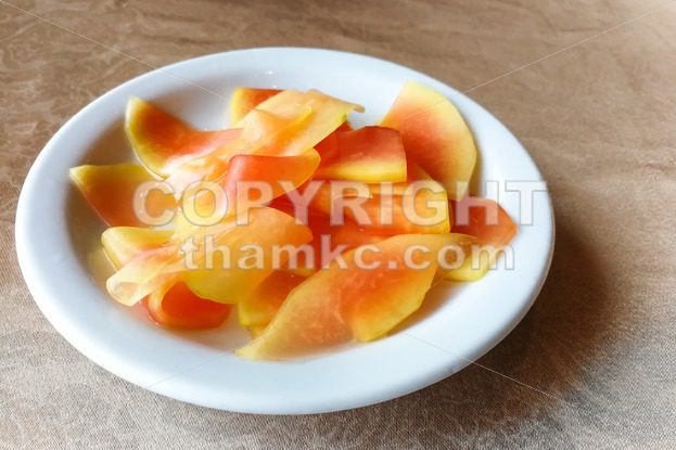 Plate of pickled papaya, delicacy in Southeast Asia - ThamKC Royalty-Free Photos