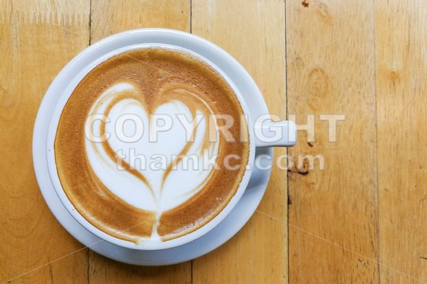 Cappuccino foam art with love heart shape on table - ThamKC Royalty-Free Photos