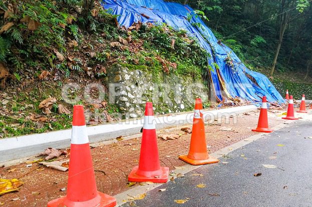 Cones barricade dangerous collapsed eroded hill slope area - ThamKC Royalty-Free Photos