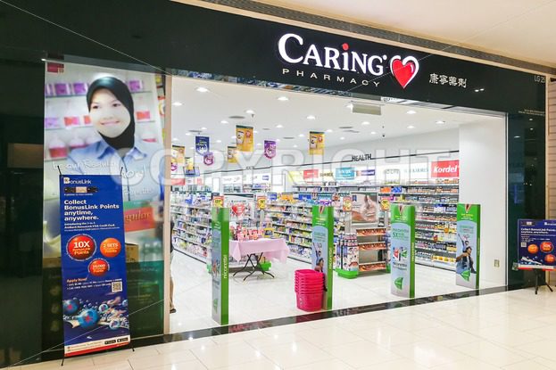 KUALA LUMPUR, Malaysia, June 25, 2017:  CARiNG Pharmacy Group Berhad operates a chain of community pharmacies They carry pharmaceutical, personal care products, medical, and healthcare devices. - ThamKC Royalty-Free Photos