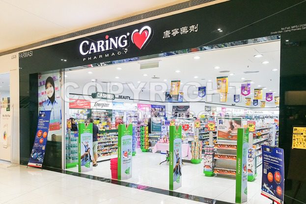 KUALA LUMPUR, Malaysia, June 25, 2017:  CARiNG Pharmacy Group Berhad operates a chain of community pharmacies They carry pharmaceutical, personal care products, medical, and healthcare devices. - ThamKC Royalty-Free Photos