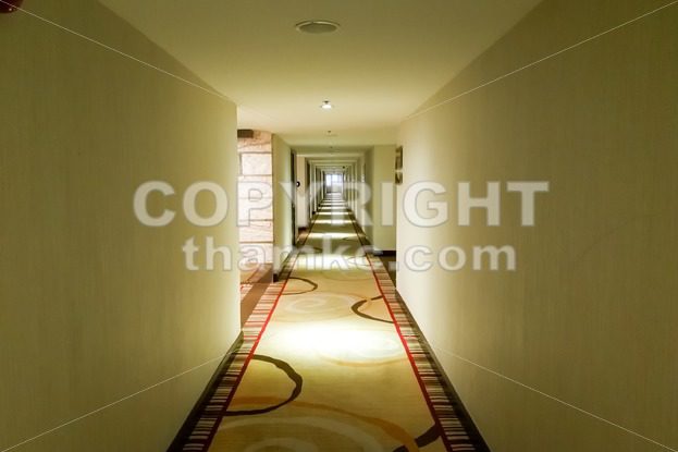 Long dark corridor with light from ceiling - ThamKC Royalty-Free Photos
