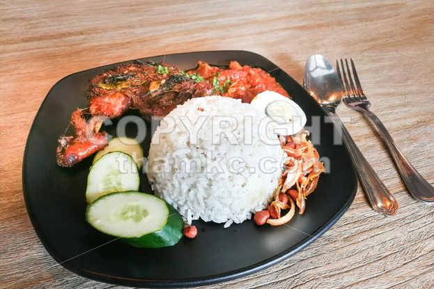 Nasi lemak with fried chicken, popular cuisine in Malaysia - ThamKC Royalty-Free Photos