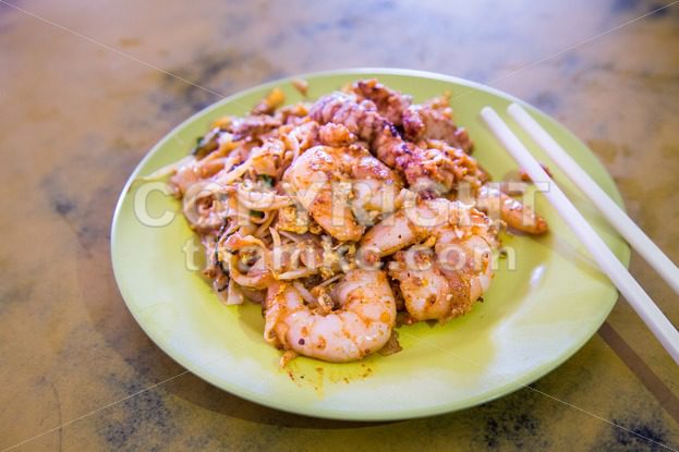 Penang Char Kuey Teow or fried noodle with big prawns - ThamKC Royalty-Free Photos