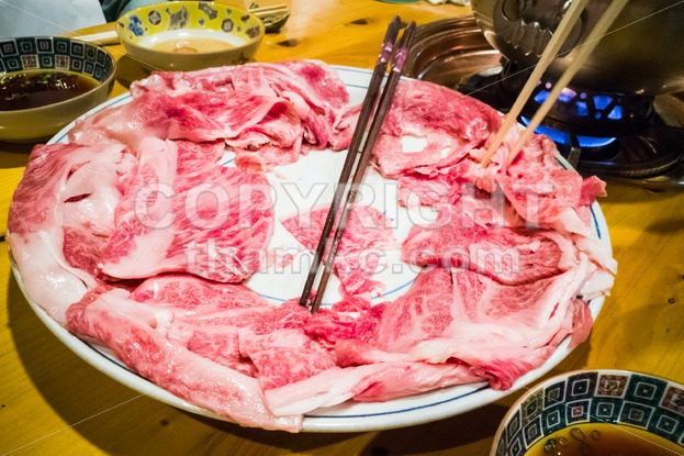 People dining with raw Japanese kobe beef shabu-shabu steamboat - ThamKC Royalty-Free Photos