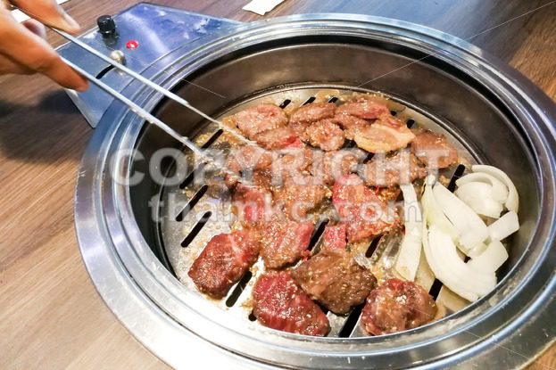 Person barbecue beef on bbq pit during korean meal set - ThamKC Royalty-Free Photos