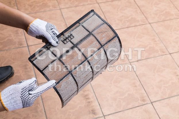 Person pointing on thick dirty dust on air conditioner filter - ThamKC Royalty-Free Photos