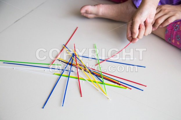 Series of kid playing pick up sticks fun game - ThamKC Royalty-Free Photos