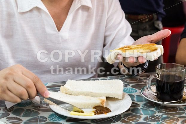 Series of person applying butter and kaya to steamed bread - ThamKC Royalty-Free Photos