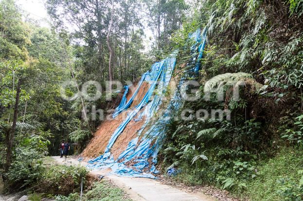 Soil erosion at tropical hilly terrain due to rain storm. - ThamKC Royalty-Free Photos
