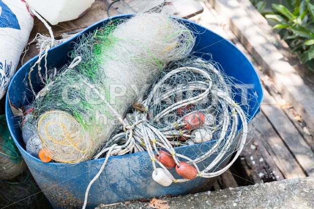 Traditional fisherman net, float and rope folded up - ThamKC Royalty-Free Photos
