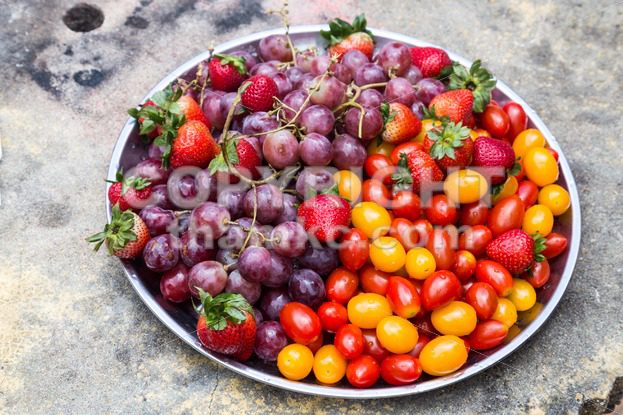 Tray of fresh and sweet organic grapes, strawberries, cherry tomatoes - ThamKC Royalty-Free Photos