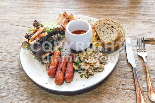 Big breakfast of sausage, mushroom, baked beans, salad wholemeal bread - ThamKC Royalty-Free Photos