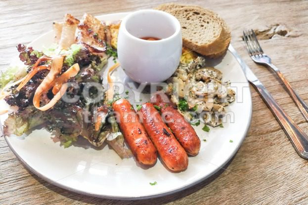 Big breakfast of sausage, mushroom, baked beans, salad wholemeal bread - ThamKC Royalty-Free Photos