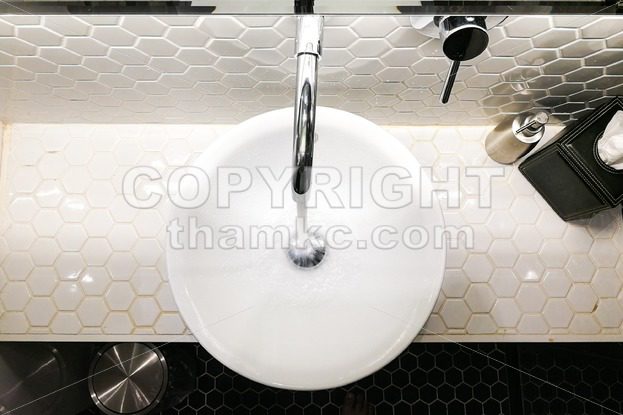 Modern contemporary wash basin with running water from tap faucet - ThamKC Royalty-Free Photos