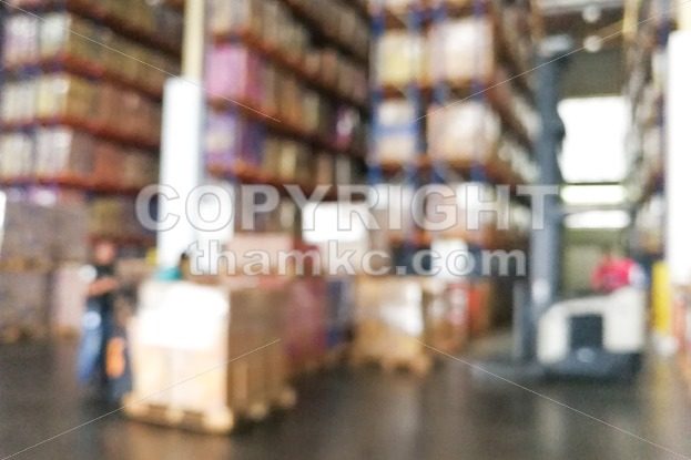 De-focused warehouse racks with inventory - ThamKC Royalty-Free Photos