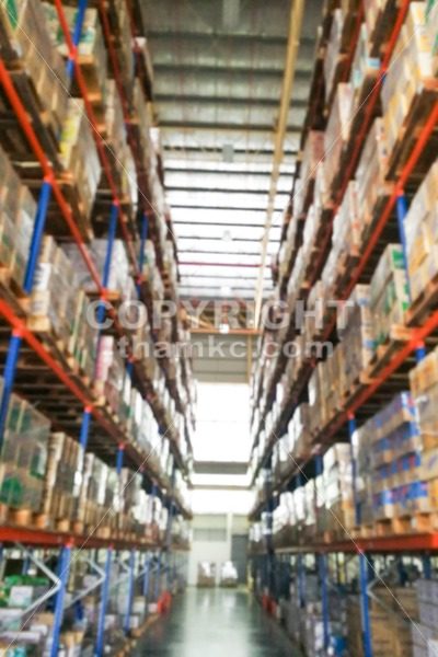 De-focused warehouse racks with inventory - ThamKC Royalty-Free Photos