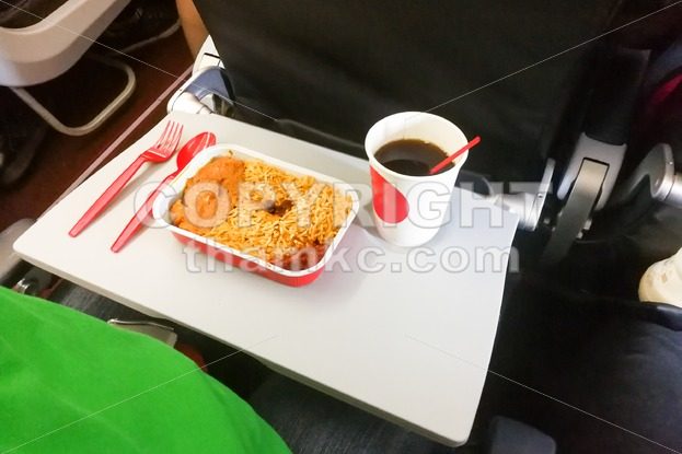 Simple in-flight meal of rice, meat, coffee in disposable utensils - ThamKC Royalty-Free Photos