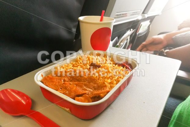Simple in-flight meal of rice, meat, coffee in disposable utensils - ThamKC Royalty-Free Photos